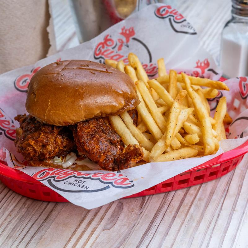 Eugene's Hot Chicken signature dishes Hot Chicken (various pieces and heat levels – e.g., "Stupid Hot"), Hot Chicken Sandwich, Southern Greens, Mac & Cheese, Banana Pudding.